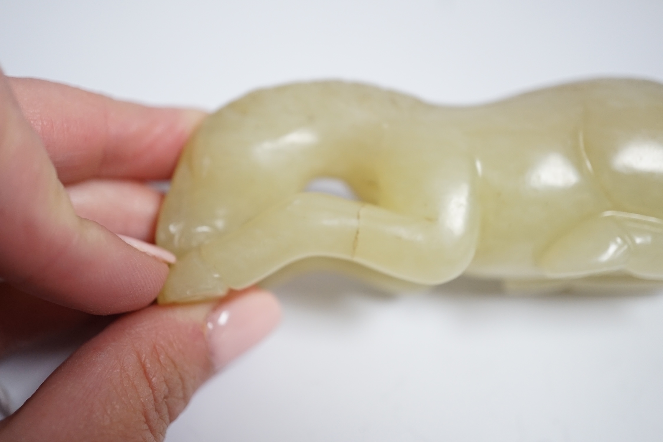Two Chinese carved jade figures of horses on stands, largest 11cm wide